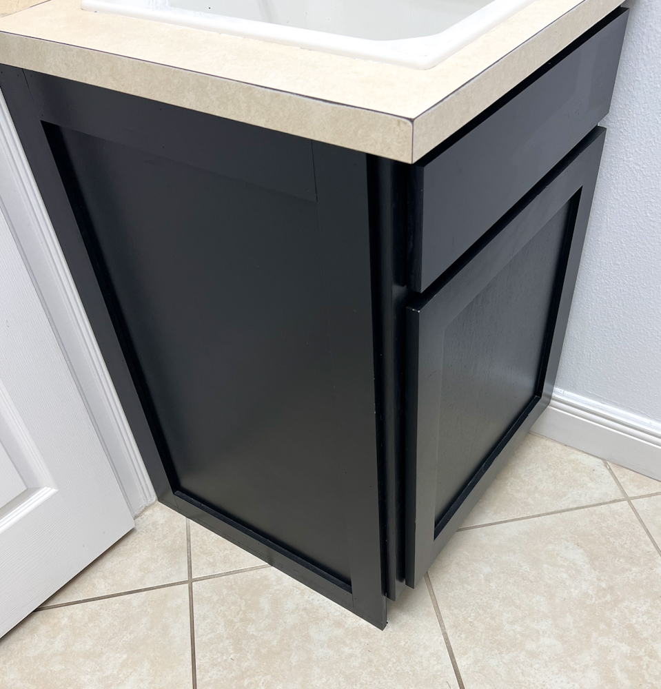 Learn how we made our own shaker style cabinets in this black and white laundry room makeover.