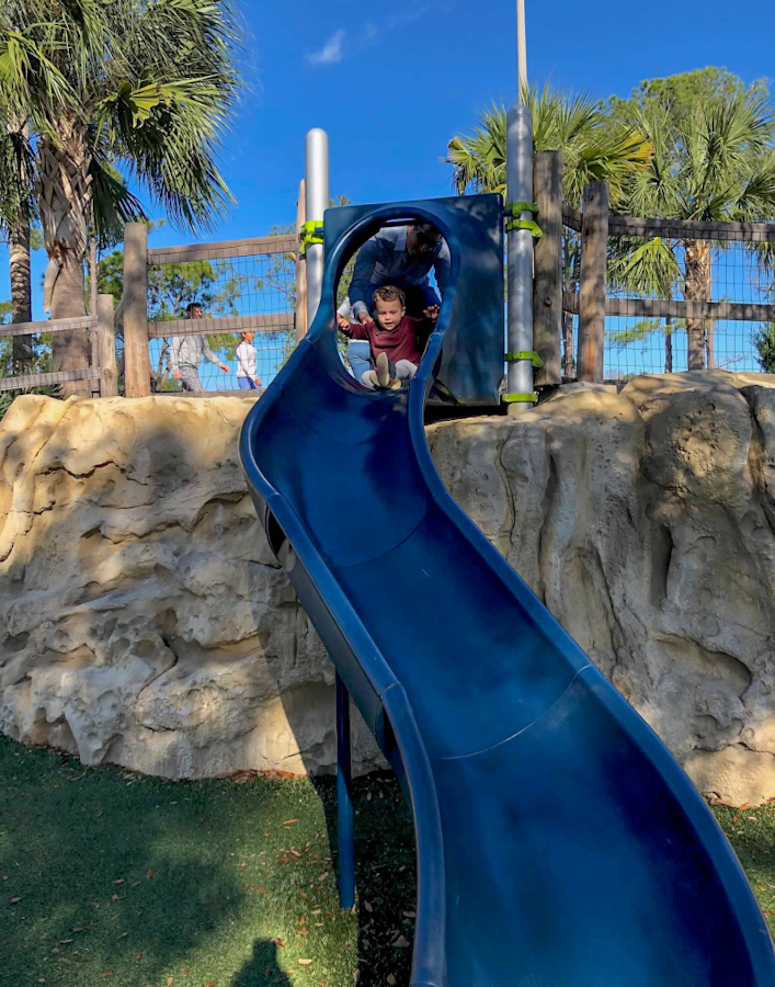 Roman getting ready to go down the slide at James F Holland Memorial Park in Palm Coast, Florida