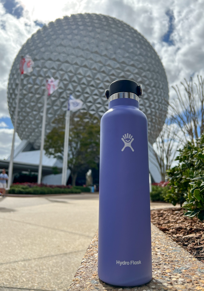 Purple Hydro Flask water bottle set in front of the Epcot ball at Walt Disney World