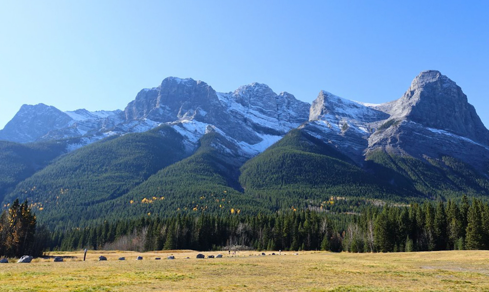 on a walking path in Canmore Canada with the beautiful snowcapped mountains in the background