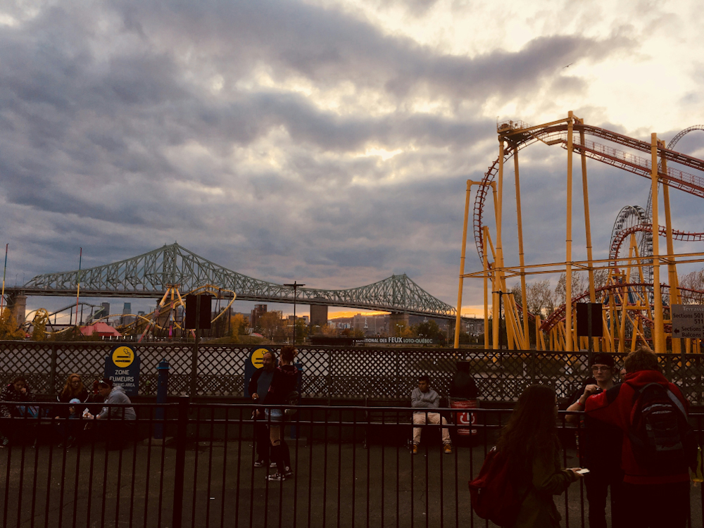 View of La Ronde (Six Flags) in Montreal Canada from along the harborside with views of the bridge over St. Lawrence River in the background