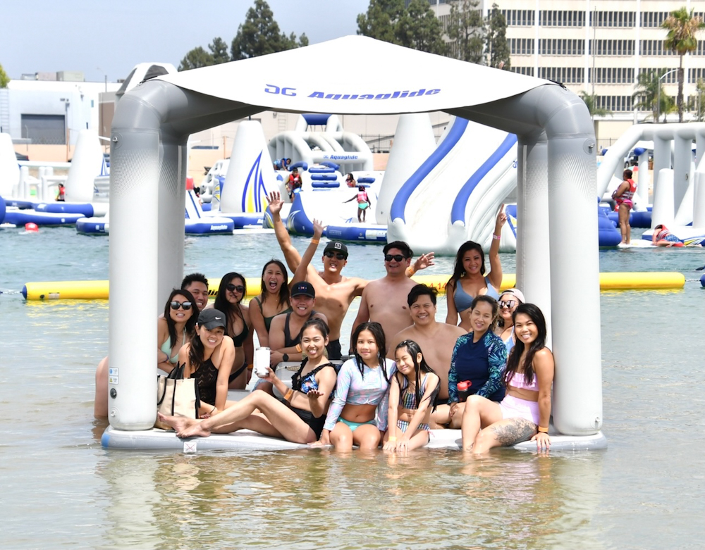 a family photo on one of the inflatable pieces in an inflatable water park