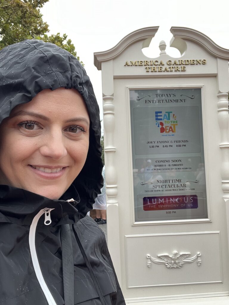 IMG 8419 2 1 wearing a rain jacket with a hood on in front of the America pavilion at Walt Disney World's Epcot