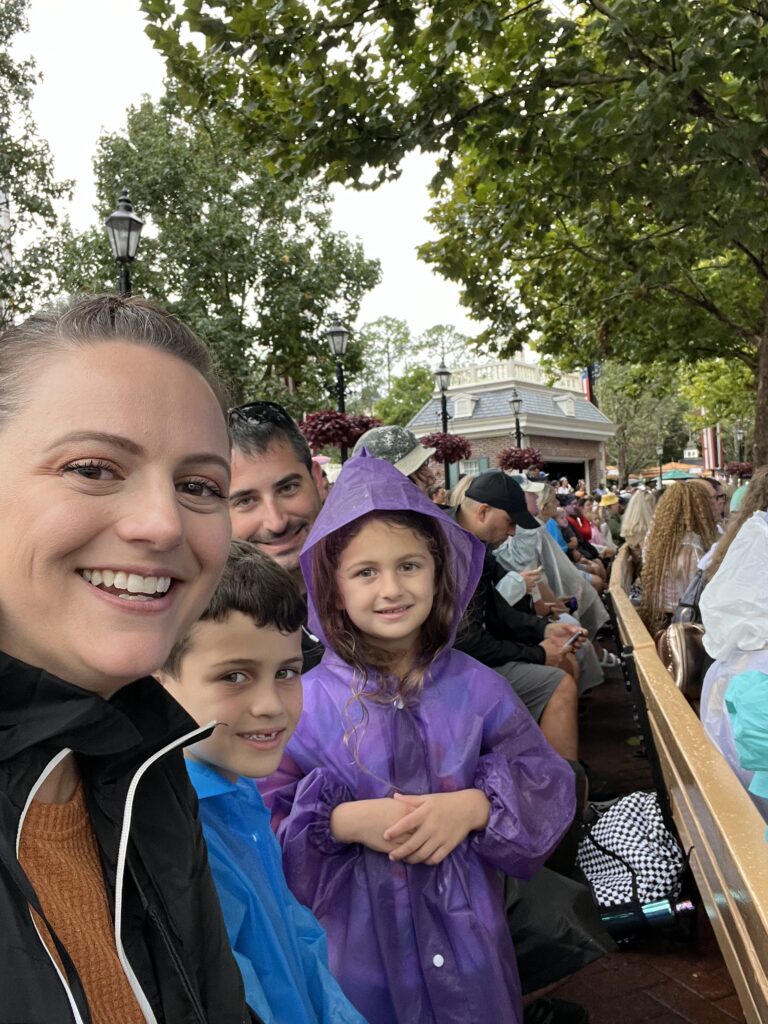 IMG 8445 1 family in rain gear at the America pavilion at Walt Disney World's Epcot