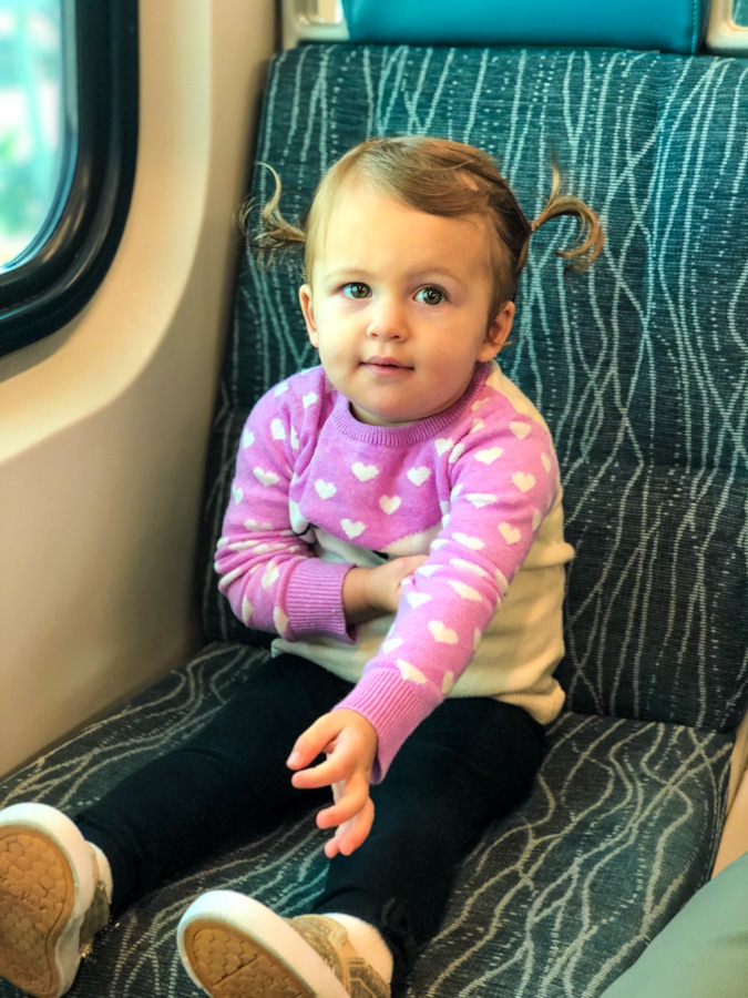 baby girl sitting in a train seat