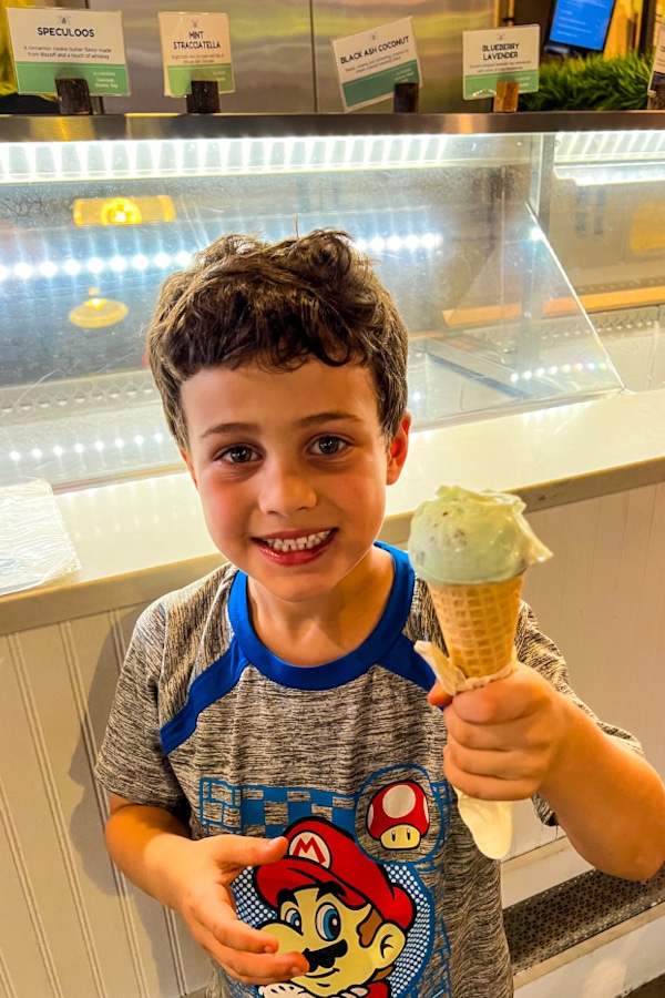 little boy holding an ice cream cone at one of the restaurants in Sanford Florida, The Greenery Creamery