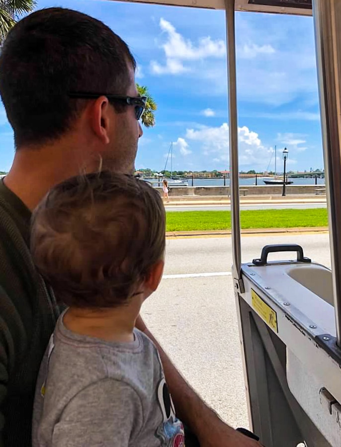 parent and child on the St. Augustine Trolley looking out at the intracoastal waterway