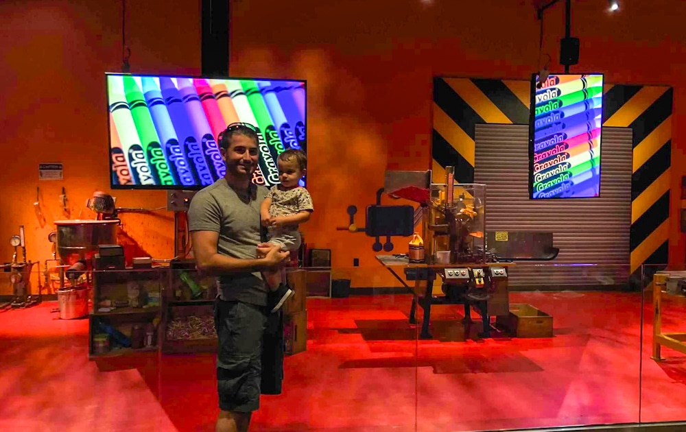 father and son in front of the live show room at the Crayola Experience