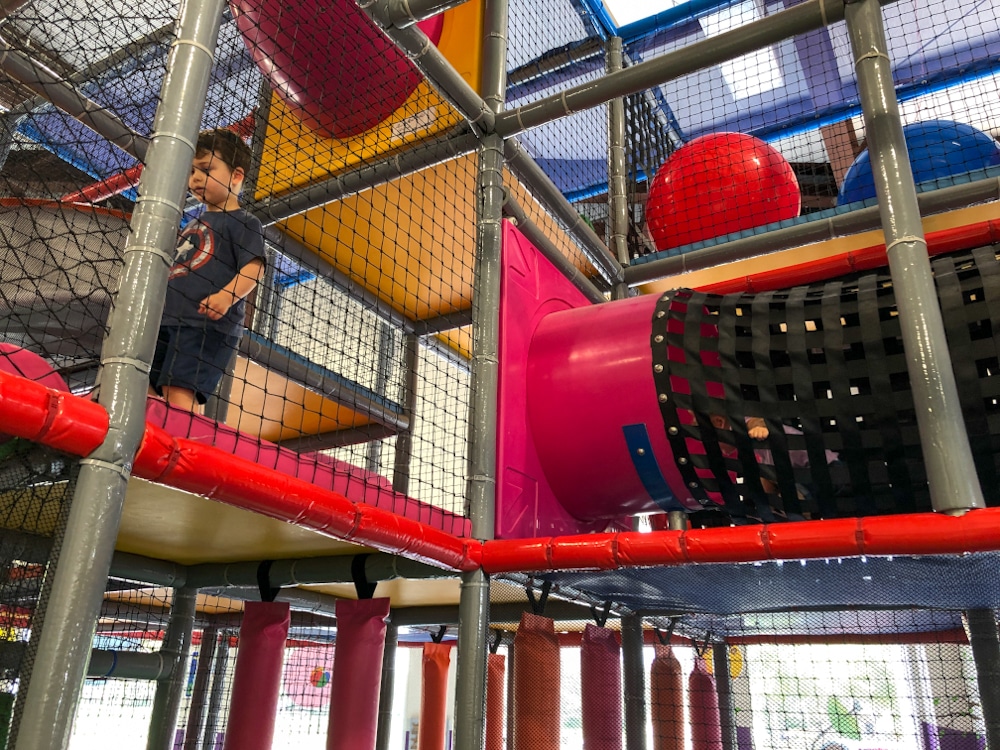 little boy walking through a 3 story playplace