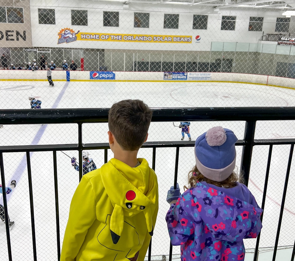 brother and sister children watching the Orlando Solar Bears practice at the Orlando Ice Den