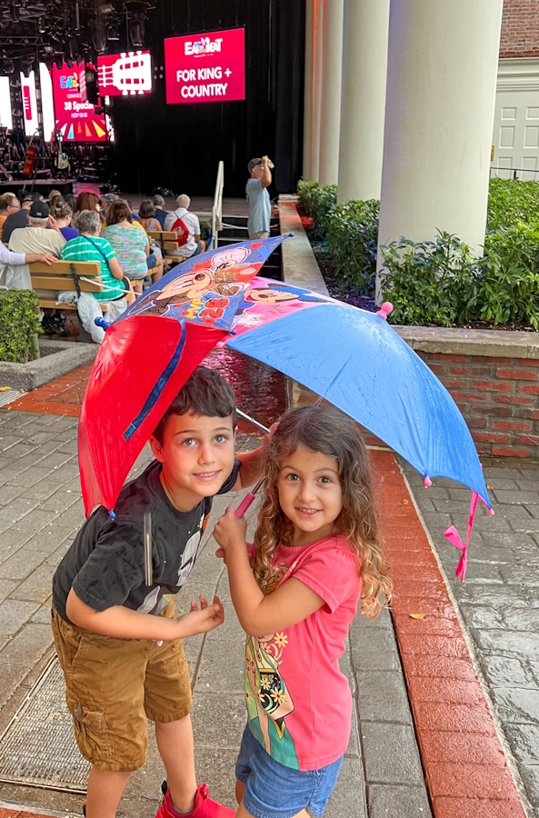 kids with mickey and minnie umbrellas waiting for eat to the beat at Disney's Epcot