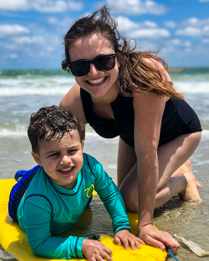 My son and I at the beach. He is on a yellow boogie board.