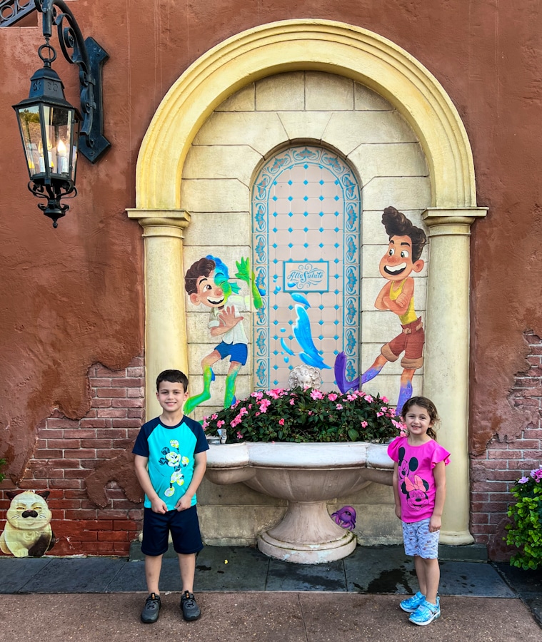 kids in front of the Luca mural at the Italy pavilion in Disney's Epcot